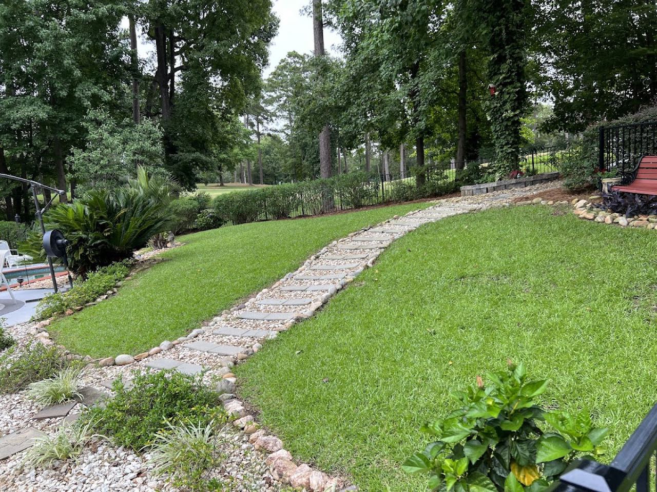 Completed landscaping with stone path and manicured lawn